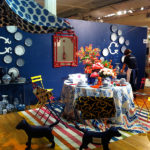 C. Wonder's Asian inspired vignette includes a fiery, bamboo fretwork mirror.