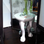 This white claw foot stool reminds me of John Dickinson's "African" plaster side table.