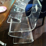 Z lucite chairs pair well with wood in Yetta Banks' vignette.