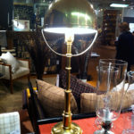 The round brass lampshade looks nautical and Steampunk.